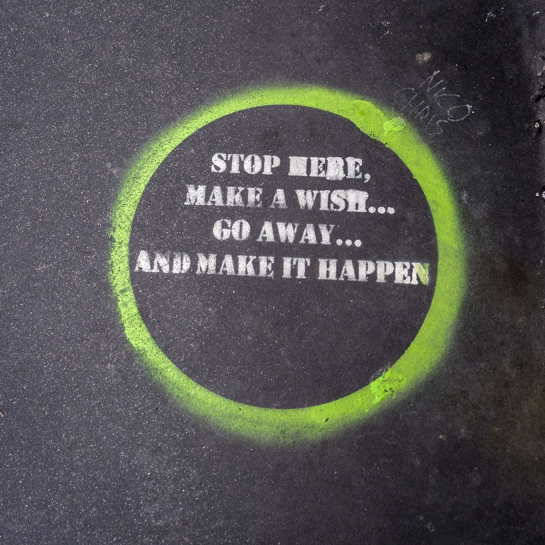 A green circle with a message on it that says "Stop here, make a wish... Go away... And make it happen"